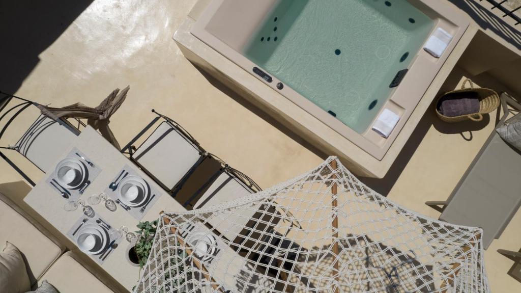 an overhead view of a bathroom with a sink and a mirror at OIA UNIQUE HOMES by K&K in Oia