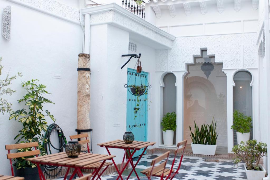 an outdoor patio with two tables and chairs at Altabib Riad in Córdoba