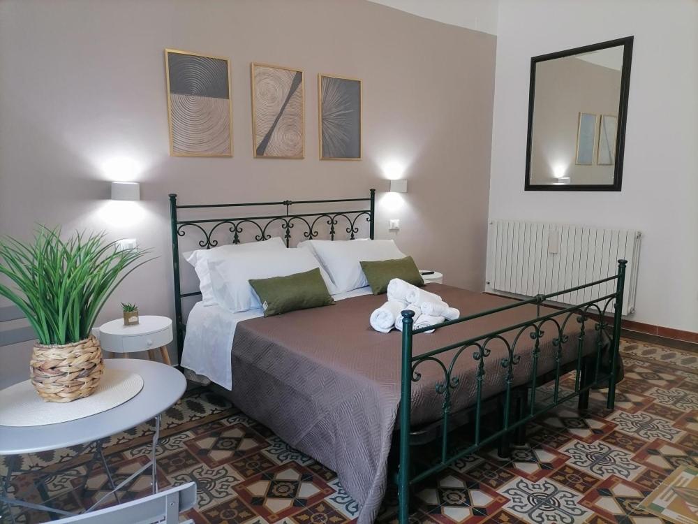 a bedroom with a bed and a table in a room at AREMU in Lecce