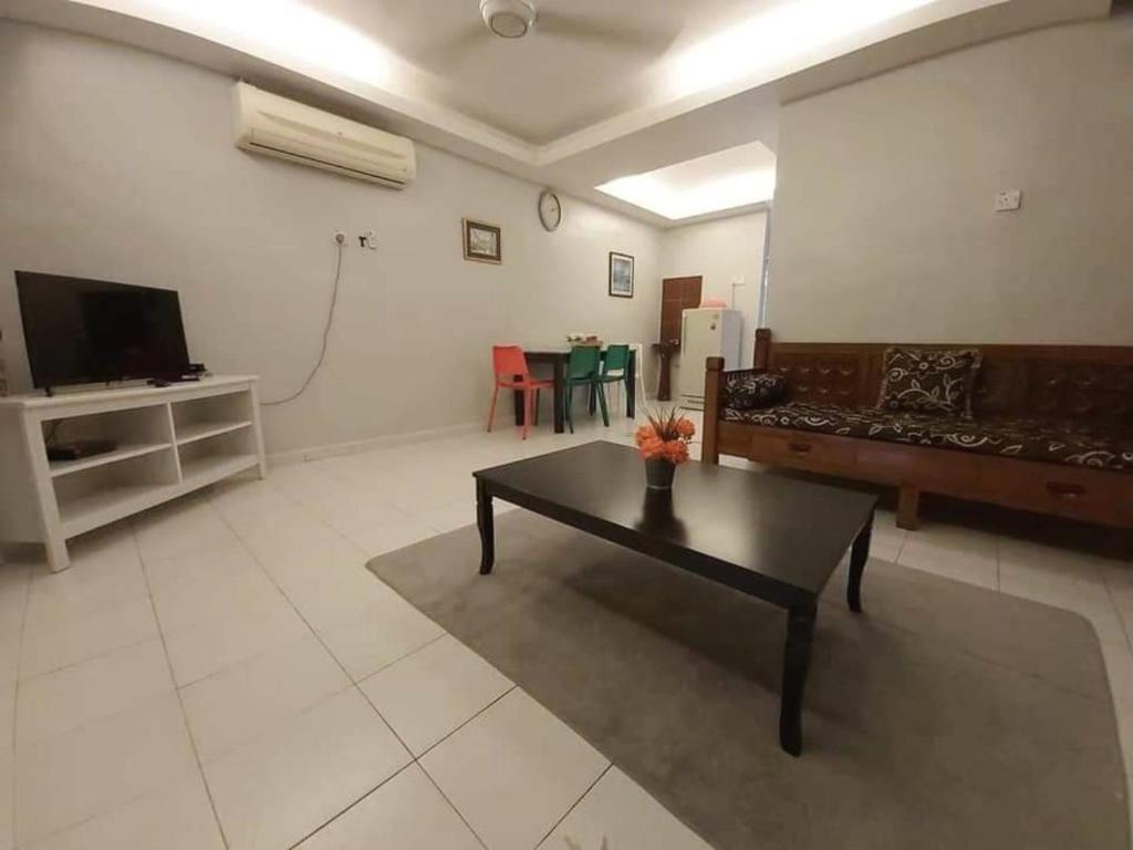 a living room with a couch and a coffee table at Juwita Homestay Bukit Katil - Free Unifi and 15 Minutes To Town in Malacca