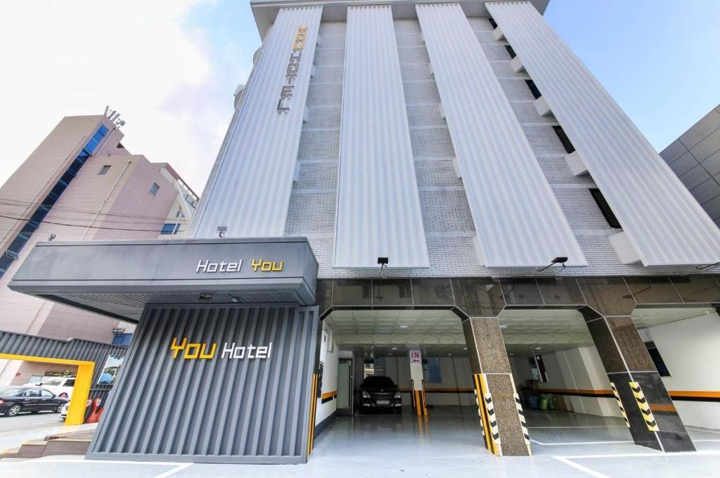 un edificio de gran altura con entrada al hotel Hilton en Hotel YOU, en Yeosu