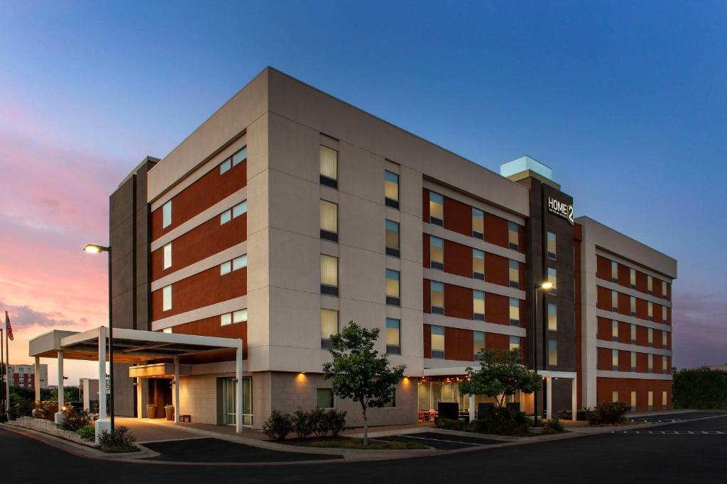 a rendering of a hotel building at dusk at Home2 Suites by Hilton Austin Round Rock in Round Rock