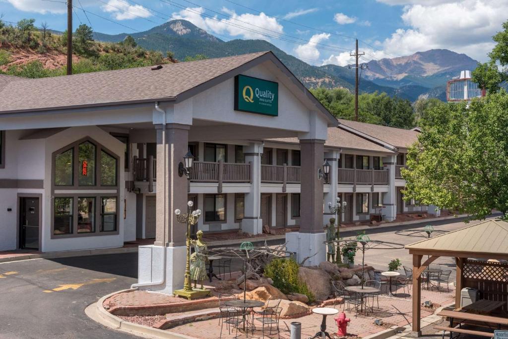 an image of a hotel with mountains in the background at Quality Inn & Suites Manitou Springs at Pikes Peak in Manitou Springs