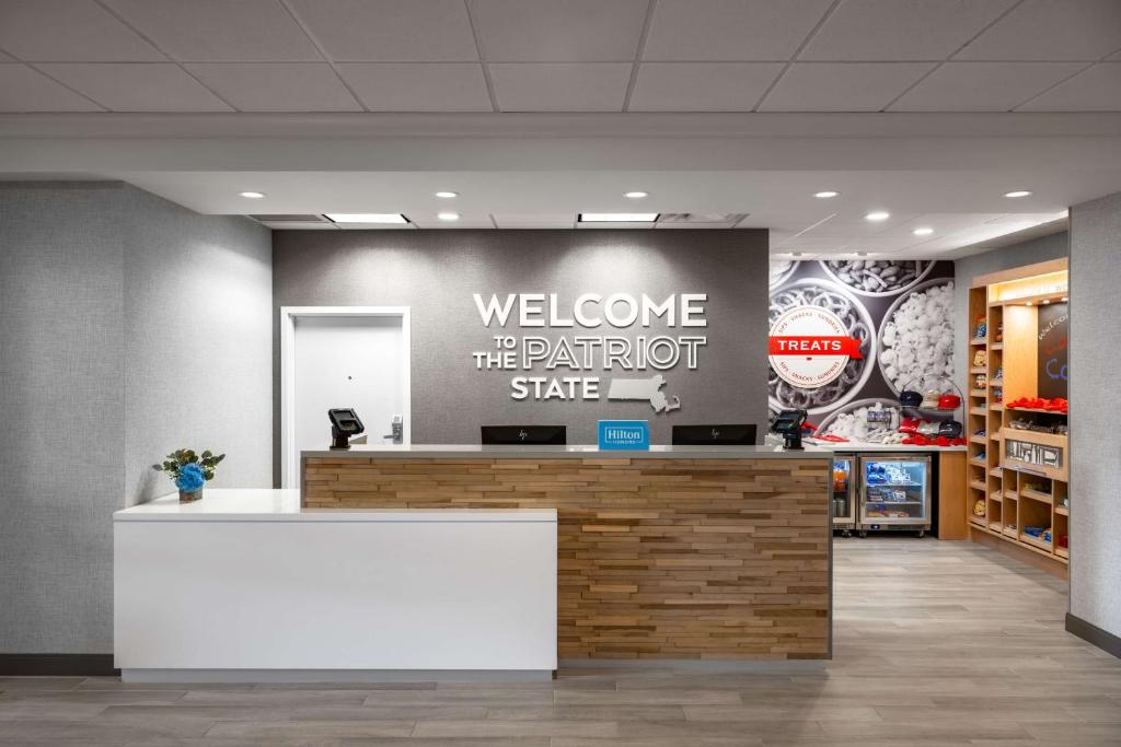 a lobby with a welcome to the platinum state sign on a wall at Hampton Inn & Suites - Cape Cod / West Yarmouth in West Yarmouth