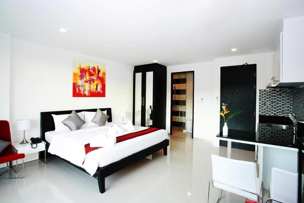 Postel nebo postele na pokoji v ubytování One World One Home Naiharn Hotel