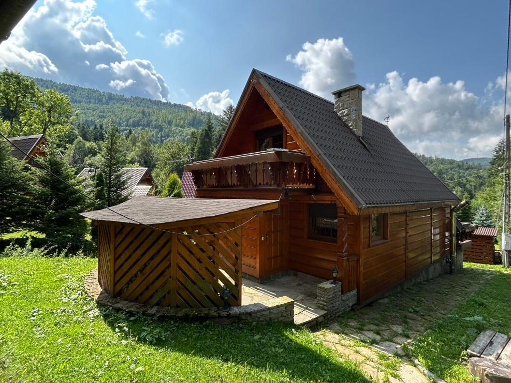 duża drewniana kabina na polu trawy w obiekcie Szczyrkowskie Historie w Szczyrku