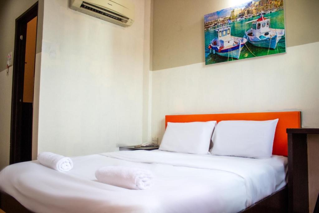 Postel nebo postele na pokoji v ubytování JQ Suria Hotel