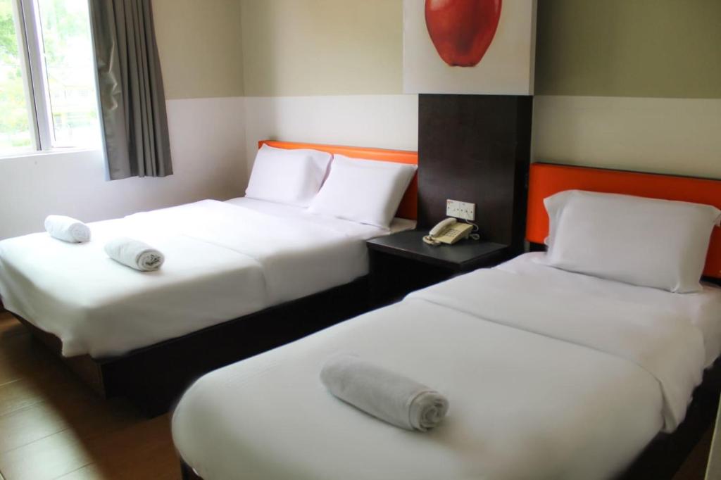 Postel nebo postele na pokoji v ubytování JQ Suria Hotel