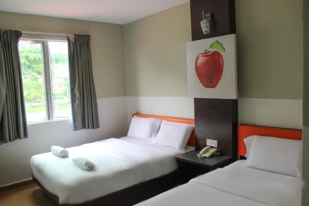 Postel nebo postele na pokoji v ubytování JQ Suria Hotel