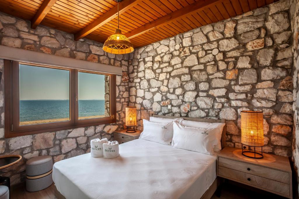 Postel nebo postele na pokoji v ubytování Dafnes Village