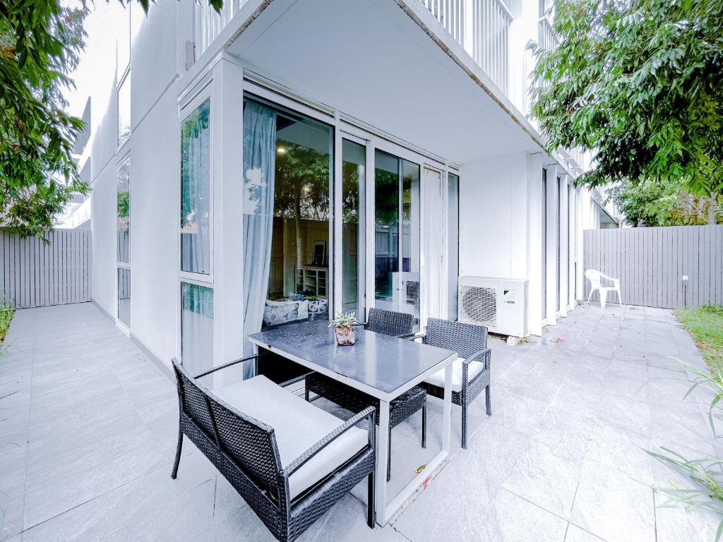 a patio with a dining table and chairs on it at BPM Brighton APT with Garden LG1 in Melbourne