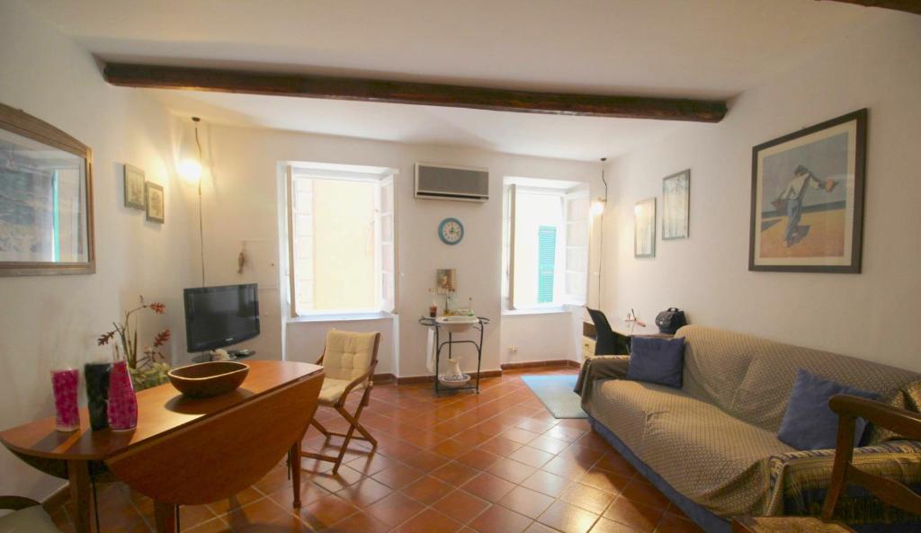 a living room with a couch and a table at La casa nel cuore di Camogli in Camogli