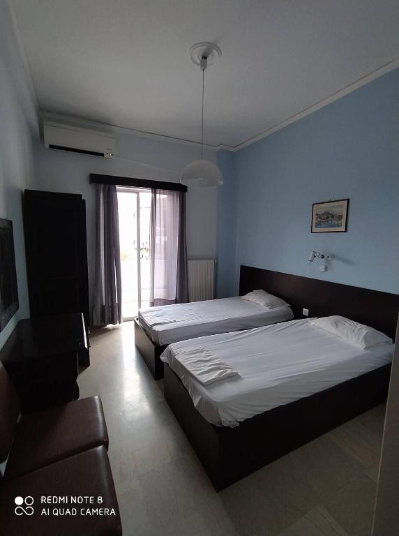 Postel nebo postele na pokoji v ubytování Dimitropoulos Apartments