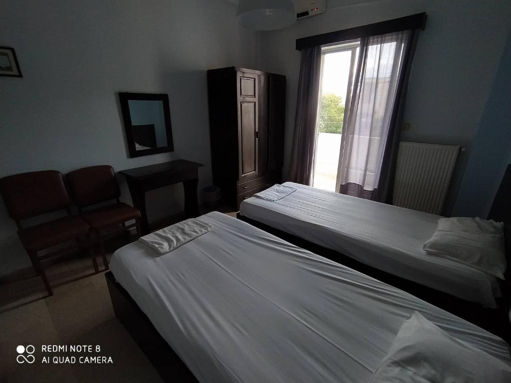 Postel nebo postele na pokoji v ubytování Dimitropoulos Apartments