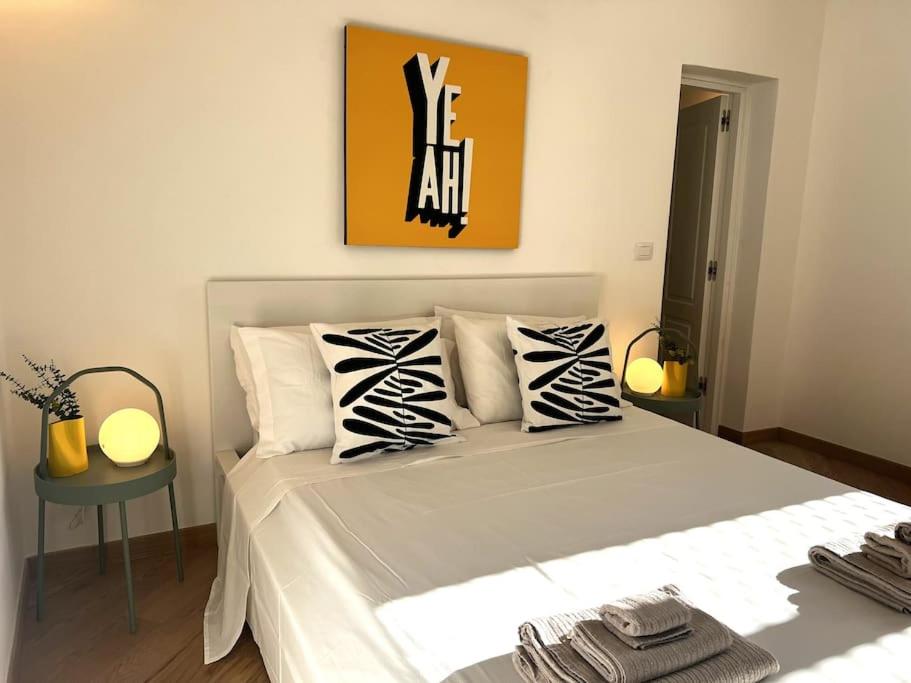 a bedroom with a large white bed with zebra pillows at Liberty Villa 2 in Bari
