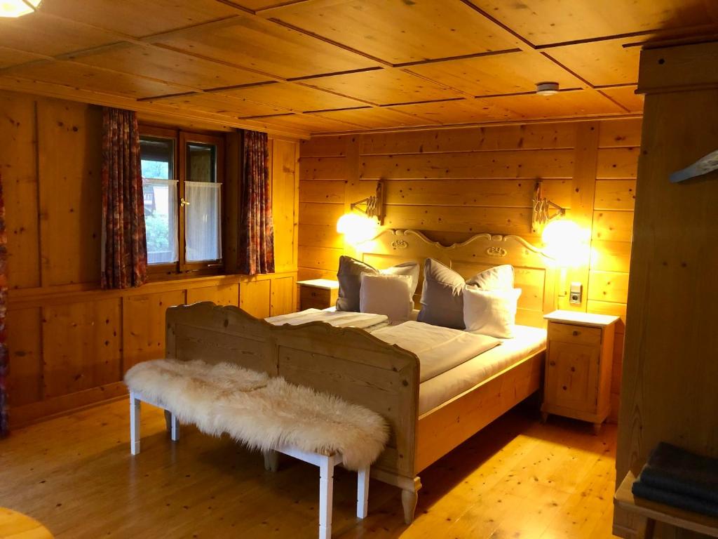 a bedroom with a bed in a log cabin at Haus Huber in Bad Hindelang