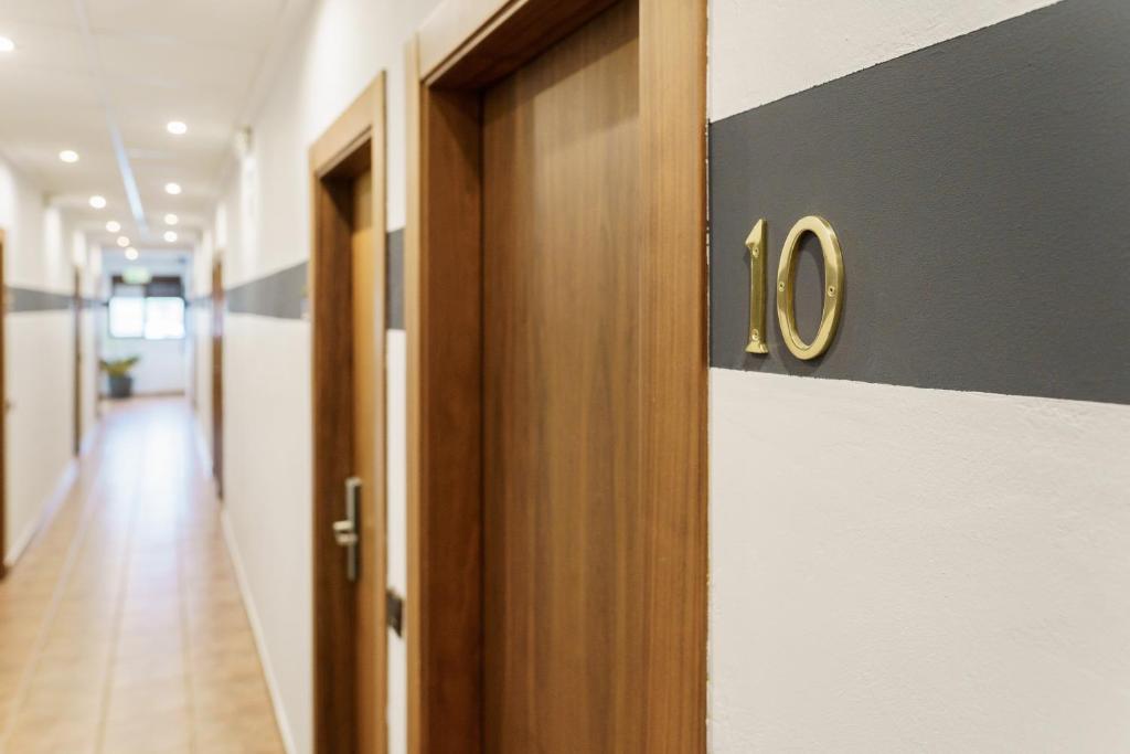 a hallway with a door with the number on it at AS HOTELES FUENTE LA HIGUERA direccion Valencia in Fuente la Higuera