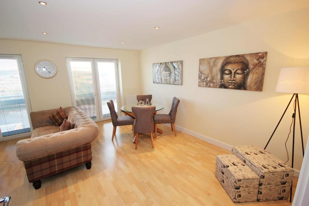 a living room with a couch and a table at High Quays Apartments - Properties Unique in Newcastle upon Tyne