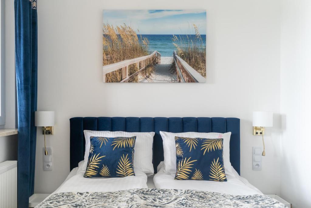 a bedroom with a bed with a picture of the ocean at Your Holidays Bel Mare Aqua in Międzyzdroje