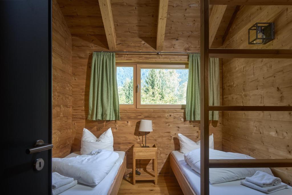 two bunk beds in a room with a window at PLUENGGAS-CHALETS in Gaschurn