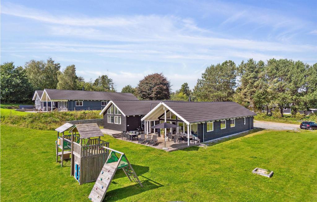 a house with a playground in the yard at Gorgeous Home In Vejby With Indoor Swimming Pool in Vejby