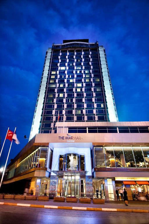a tall building with people standing in front of it at The Marmara Taksim in Istanbul