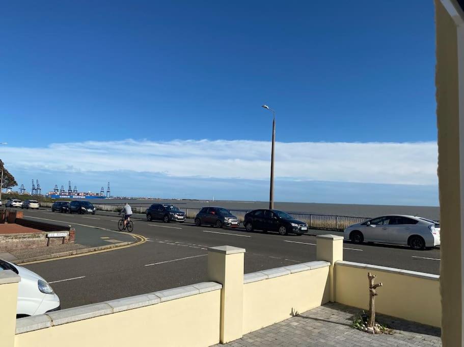 a parking lot with many cars parked next to the ocean at Space Apartments - Two Bed Seafront Apartment with Off Street Parking - Windfarmer Accommodation - Flat 1 in Harwich