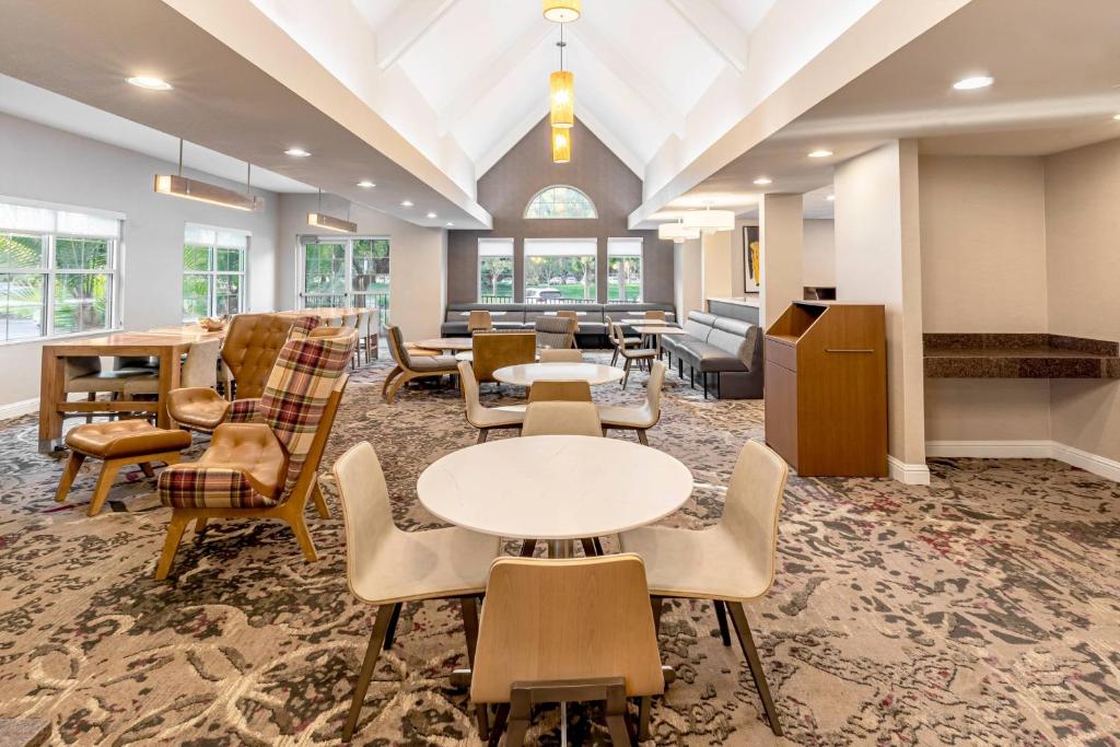 a lobby with tables and chairs and a waiting room at Residence Inn Sacramento Rancho Cordova in Rancho Cordova
