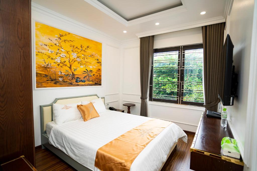 a bedroom with a bed and a large window at Hotel Trung Duong in Móng Cái