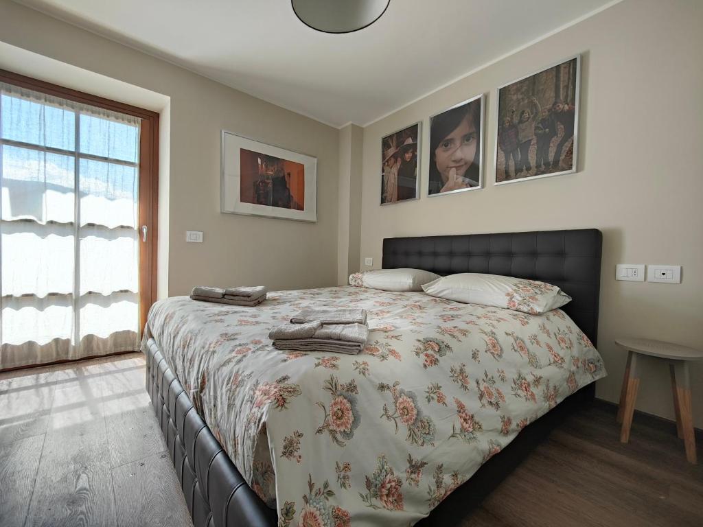 1 Schlafzimmer mit einem Bett mit Blumenbettdecke in der Unterkunft Suite a Folgaria in Folgaria