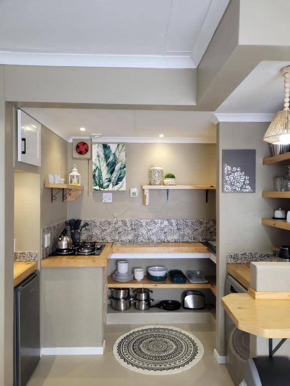 a kitchen with a stove and a counter top at Flamant Self-Catering Apartment in Velddrif