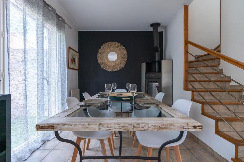 a dining room with a large wooden table and chairs at Villa Tika in Béziers
