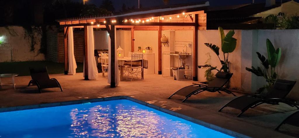 a swimming pool in a backyard at night at Villa Alicante Sunbeach in El Campello
