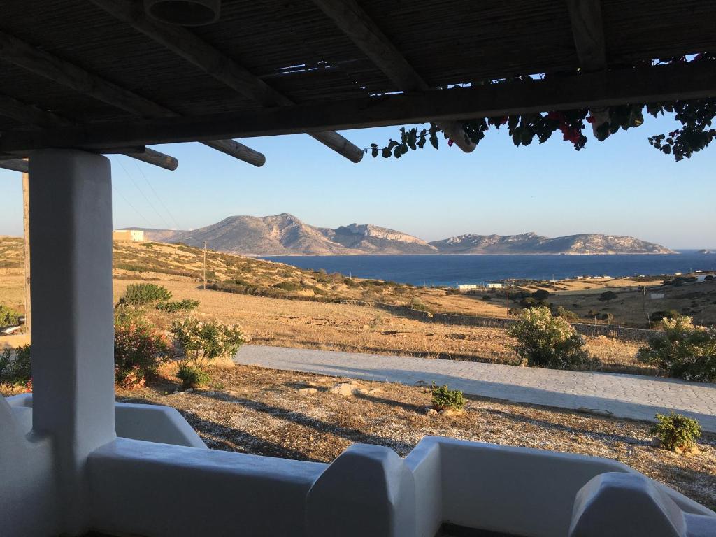 a view of the ocean and mountains from a porch at John's Houses in Koufonisia