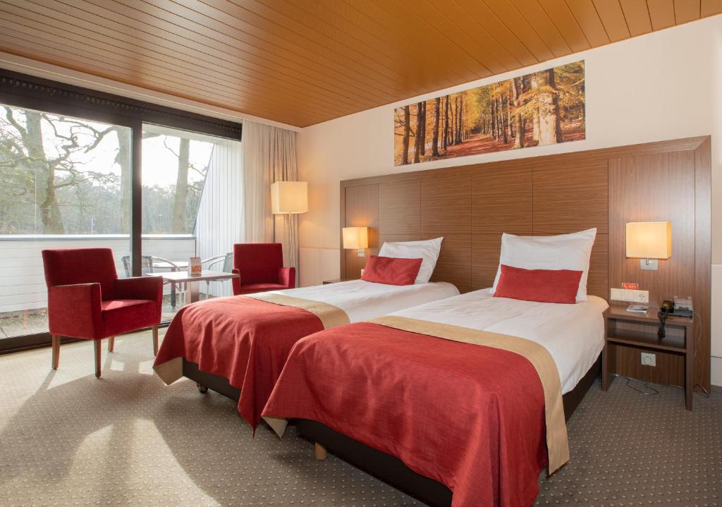 Postel nebo postele na pokoji v ubytování Fletcher Hotel-Restaurant Wolfheze