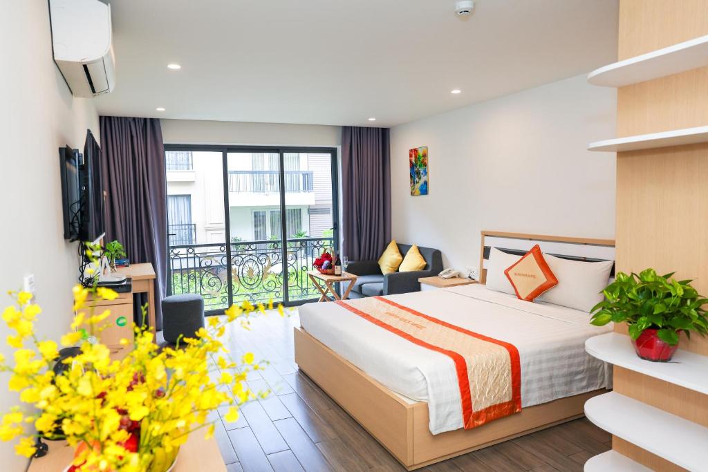 a hotel room with a bed and a balcony at Warm Ways Hotel & Serviced Apartments in Ho Chi Minh City