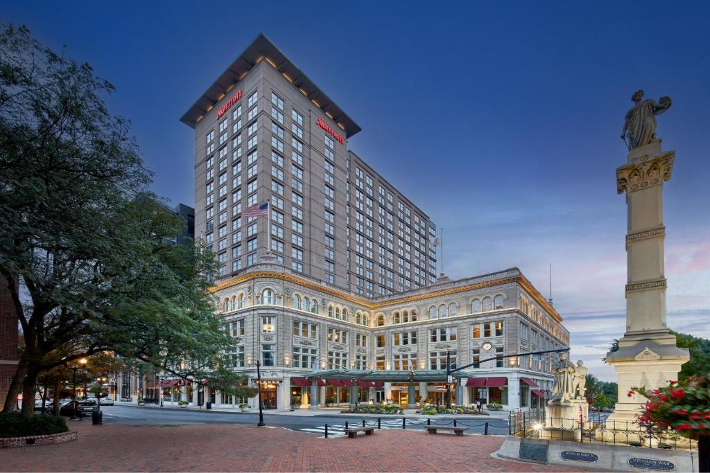 a large building with a statue in front of it at Lancaster Marriott at Penn Square in Lancaster