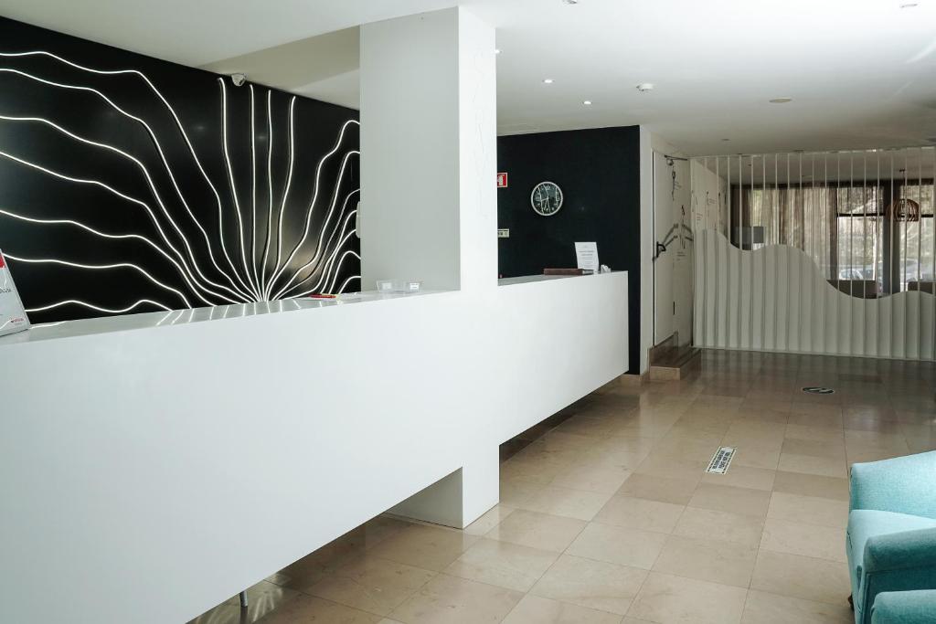 a lobby with a reception desk and a couch at Carvi Beach Hotel in Lagos