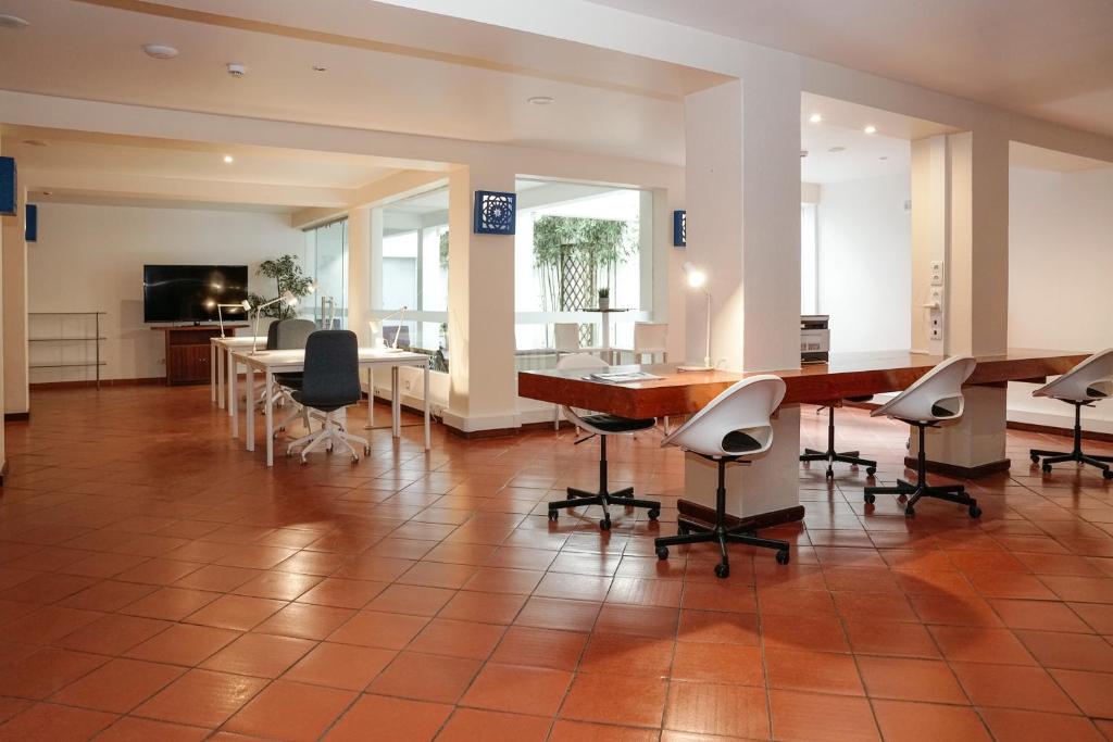 a large room with chairs and a table and a television at Carvi Beach Hotel in Lagos