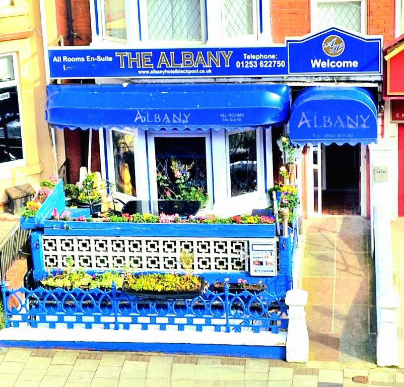 a flower shop with blue awnings on a building at The Albany hotel in Blackpool