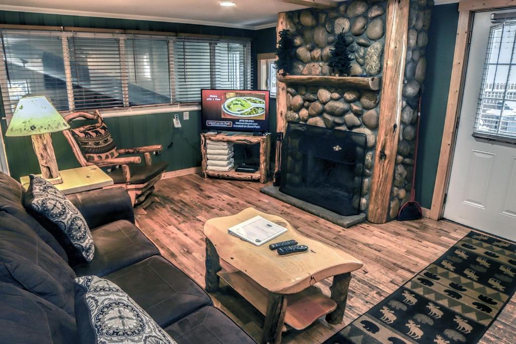 a living room with a couch and a fireplace at Timber Creek Chalets- 3 chalet in Estes Park