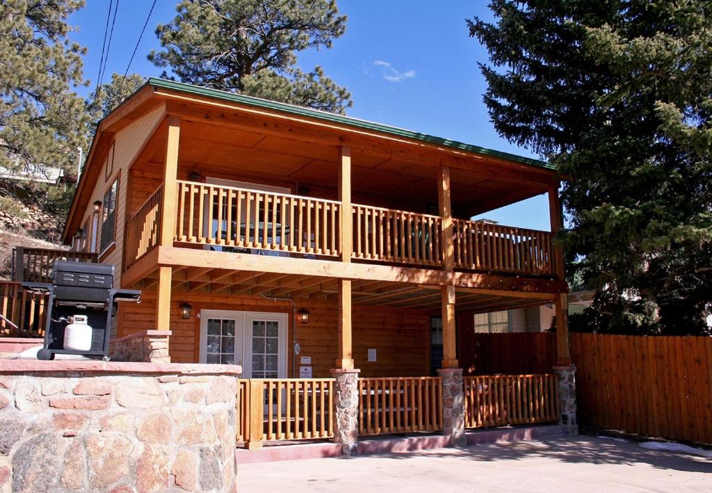 a large wooden cabin with a balcony and a fence at Lawn Lane A - #3382 in Estes Park