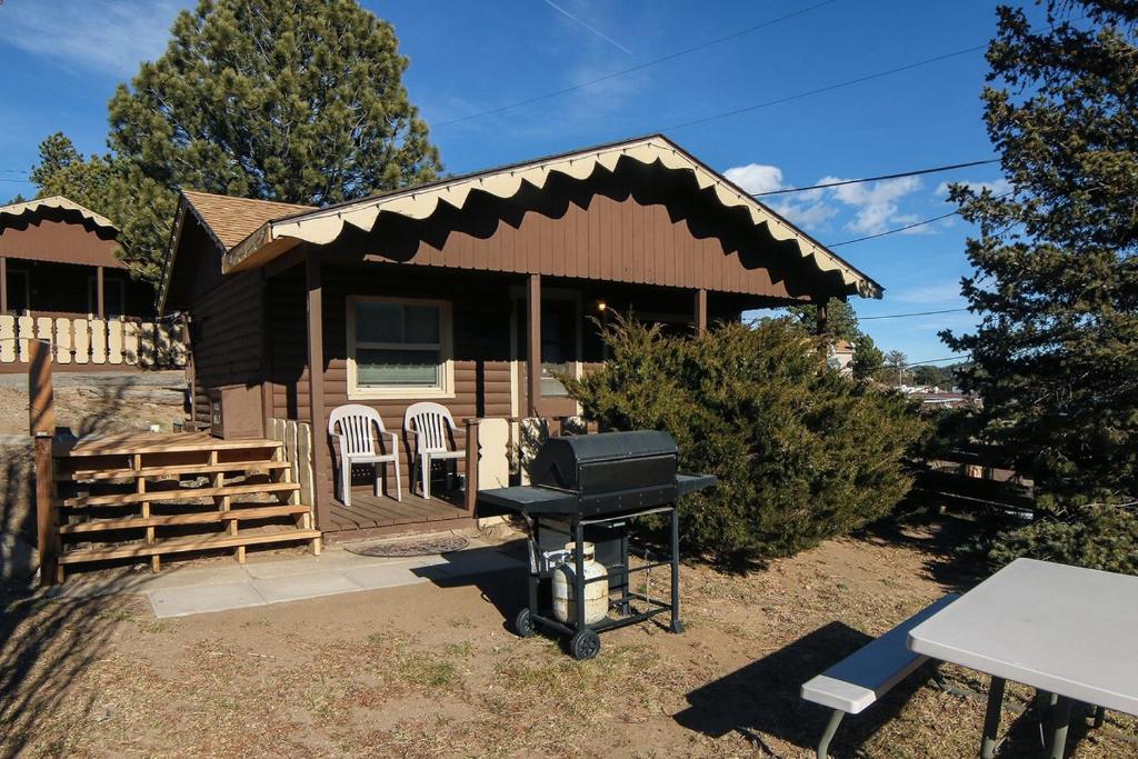 a barbecue grill in front of a house at Lazy R Cottages- 1 apts in Estes Park