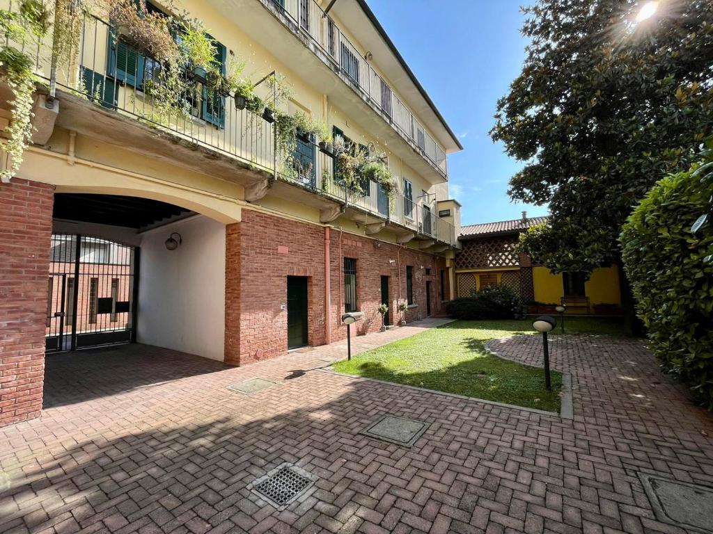 a courtyard of a building with a balcony at Guest House SanSiro Fiera in Milan