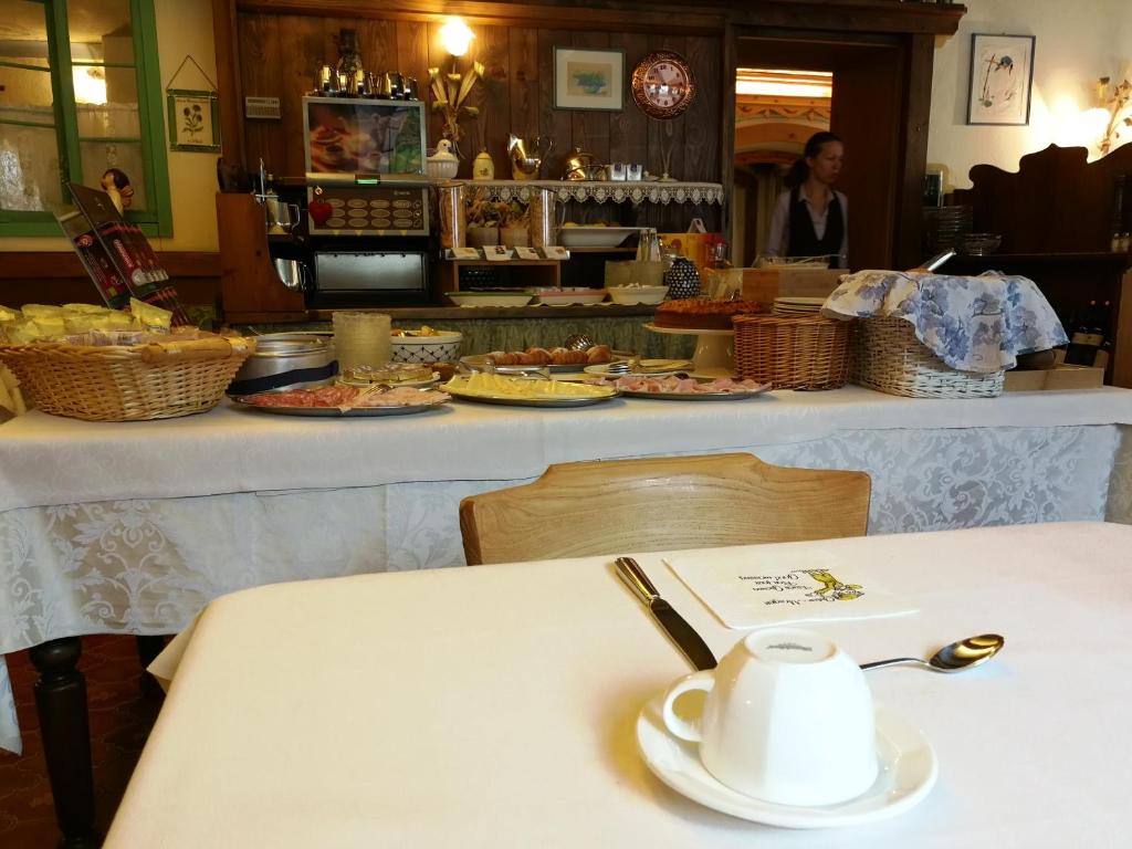 a table with a cup of coffee sitting on a table at Digonera Historic Hotel B&B in Rocca Pietore