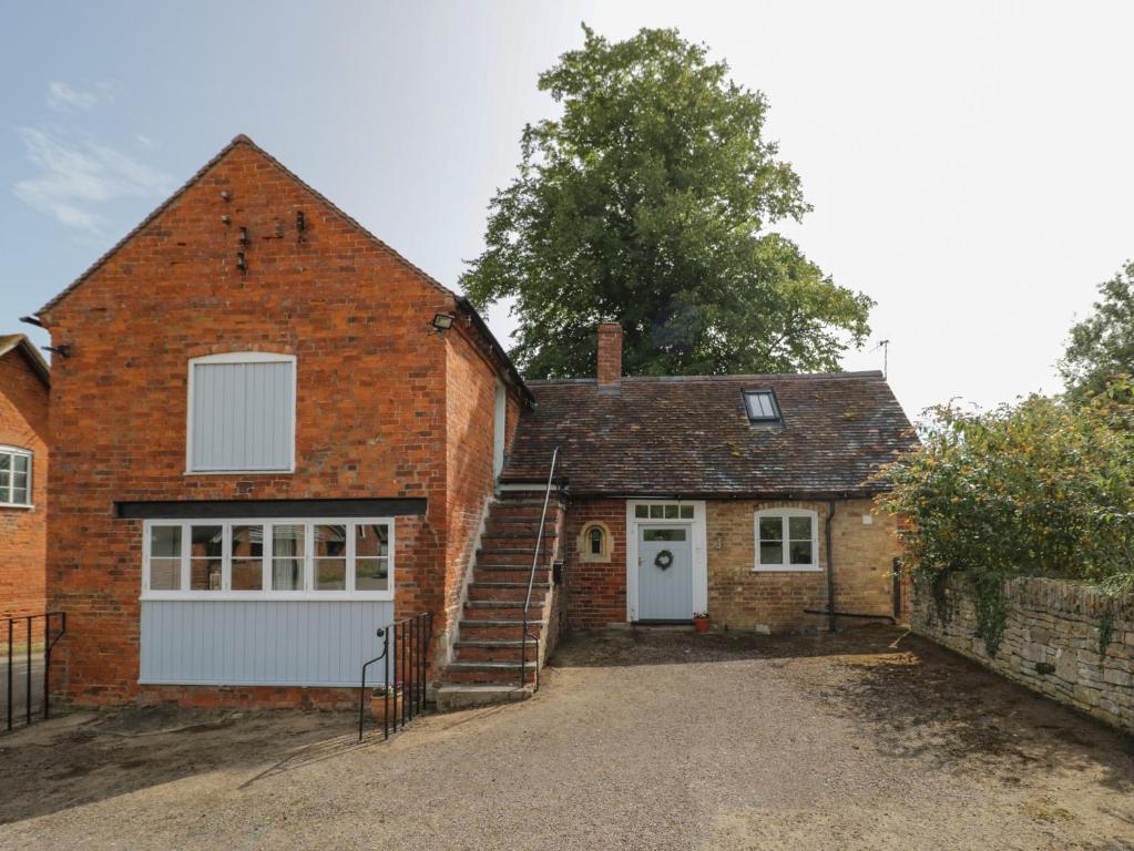 a brick house with a garage and a staircase at Chapel Cottage in Pershore