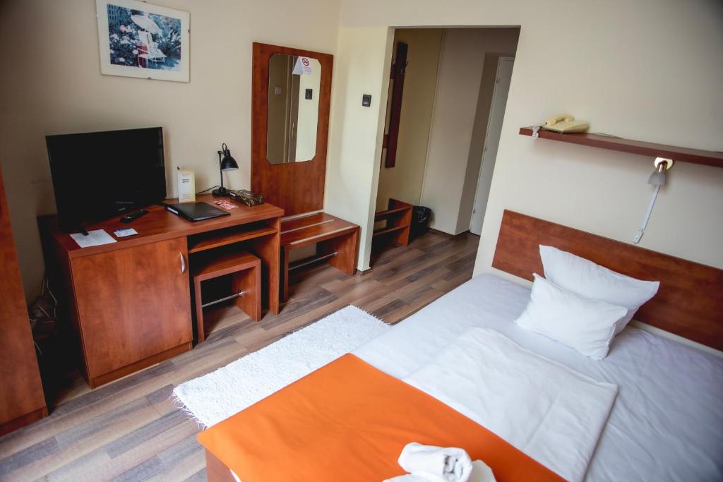 Posteľ alebo postele v izbe v ubytovaní Hotel Kapos