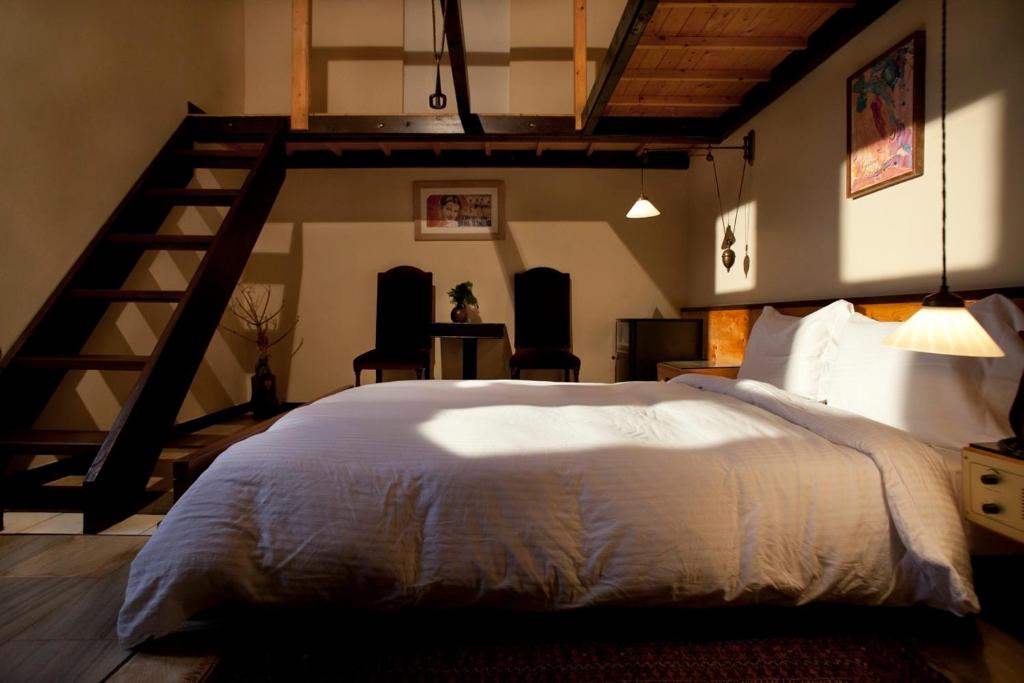 Łóżko lub łóżka w pokoju w obiekcie Lazareto Hotel