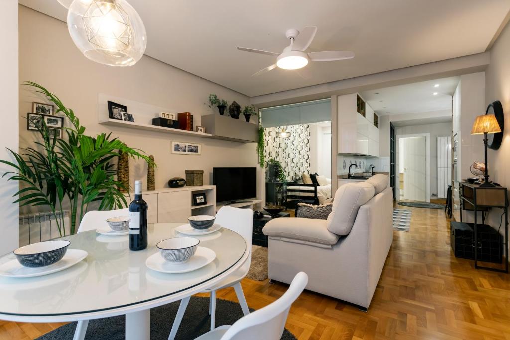 a living room with a white table and chairs at Audrey by Unique Rooms in Burgos