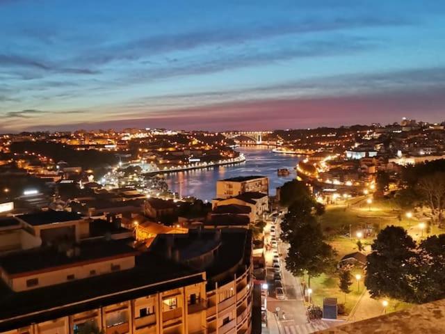 a view of a city at night with a river at Apartamentos Jardim do Morro in Vila Nova de Gaia